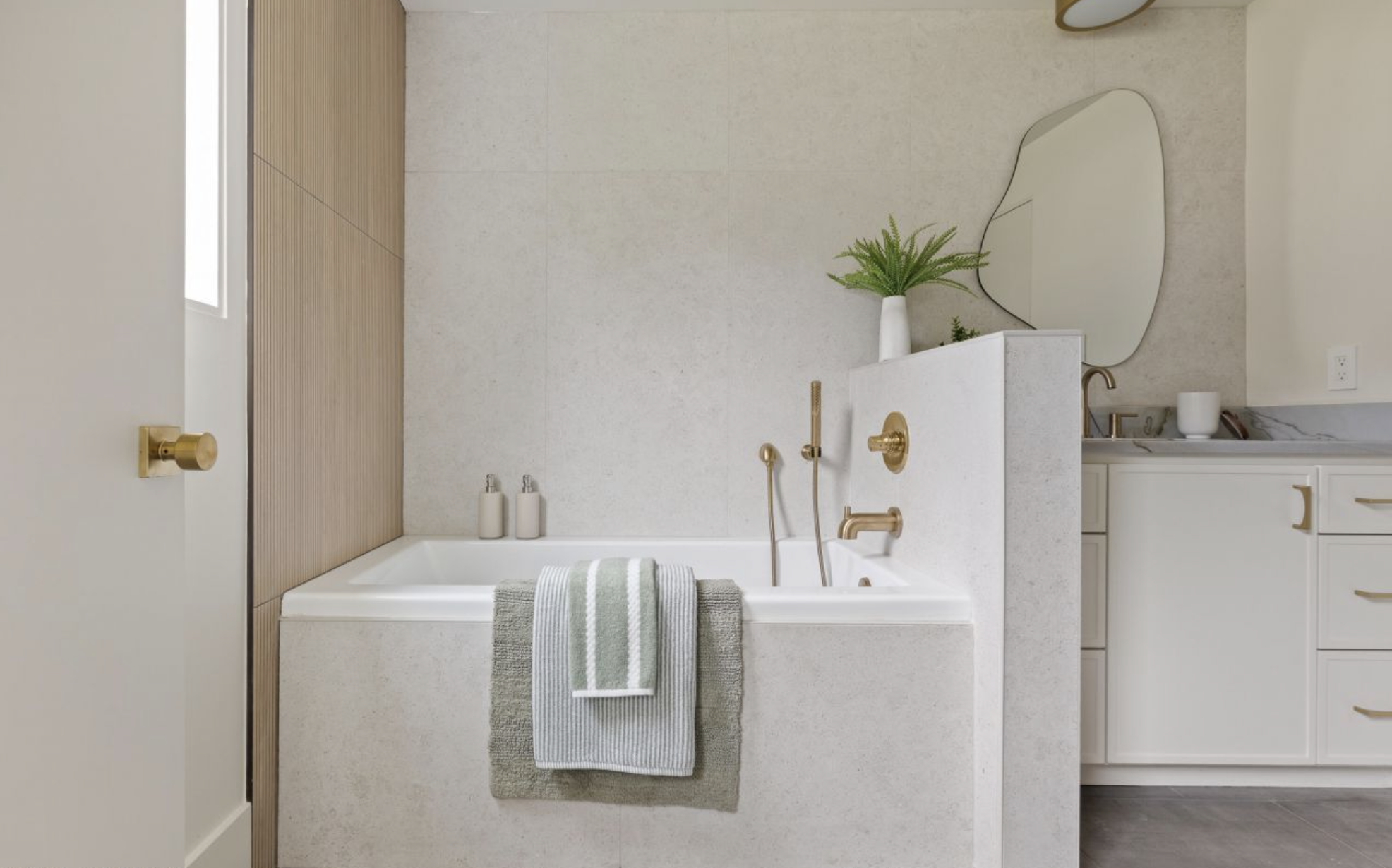 Luxurious soaking tub with brass fixtures and premium tile work